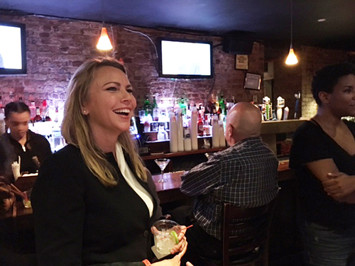 Lara Logan, CBS News journalist and CPJ board member, laughs as she watches herself participate in Jeopardy! at a viewing party CPJ held in May. Logan won the game. (CPJ/Mehdi Rahmati)