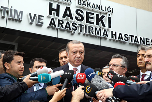 President Erdoğan talks to the press outside an Istanbul hospital in June after a police bus was attacked. At a news conference on the more recent airport attack, Turkey's leader said he was against social media. (AFP/Yasin Bulbul)