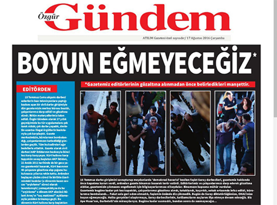 A screenshot shows the shuttered newspaper Ozgur Gundem's defiant headline, "We will not submit," August 17, 2016, the day after a court ordered the newspaper to stop publishing and police raided its offices. The socialist weekly Atilim said it published the special edition as an act of solidarity.