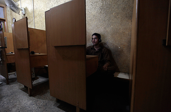 A man browses the internet at a cafe in Rawalpindi, Pakistan, in this September 18, 2013 file photo. (Reuters/Faisal Mahmood)