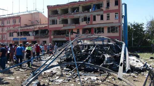 Turkish authorities search outside the damaged police headquarters after an explosion in Elazig, eastern Turkey, on August 18, 2016. Authorities banned news coverage of the blast. (Sahismail Gezici/DHA via AP)