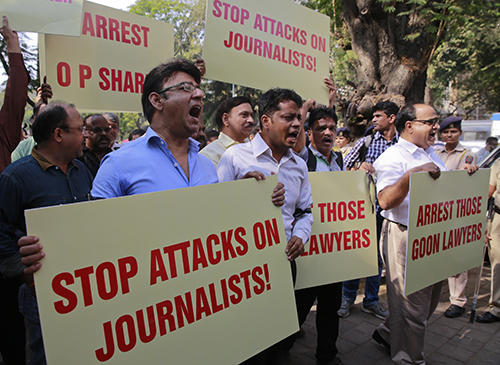 In a rare show of solidarity, journalists march together in protest after lawyers attacked members of the press outside a Delhi court house in February 2016. (AP/Rafiq Maqbool)