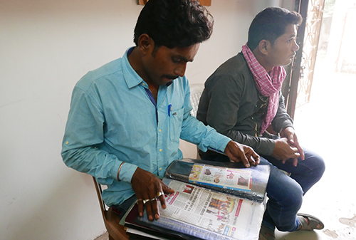 Parmeshwar Rajput looks through a file of documents related to his brother, Umesh’s, murder.  The journalist was shot dead in 2011. (CPJ/Sumit Galhotra)