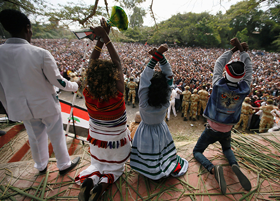 Protesters in Bishoftu, southeast of Addis Ababa, raise the Oromo protest sign ahead of an October 2, 2016, stampede that left more than 50 people dead after police fired teargas and warning shots to disperse the crowd. (Reuters/Tiksa Negeri)