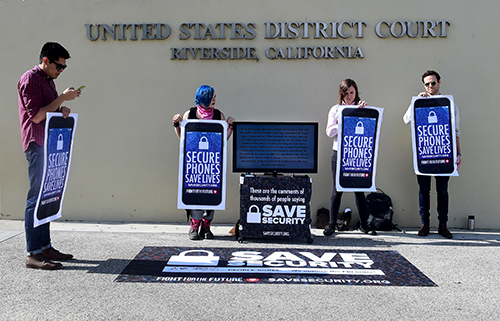 Protesters gather outside a district court in March 2016 after Apple was ordered to retrieve encrypted data from the phone of a suspected gunman. Civil rights groups say forcing companies to weaken encryption endangers privacy. (AFP/Frederic J. Brown)