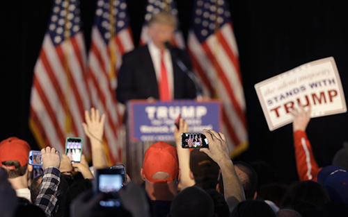 Crowds record Donald Trump on their phones during a rally in April. Journalists say they have been targeted by online trolls for their coverage of Trump. (AP/Steven Senne)