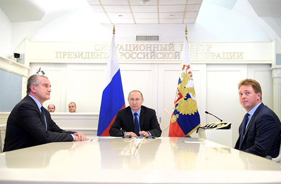 Russian President Vladimir Putin (center), head of Crimea Sergei Aksyonov (left), and then-Sevastopol Acting Governor Dmitry Ovsyannikov, take part in a video conference in Moscow, December 27, 2016. (Sputnik/Alexei Druzhinin/Kremlin via Reuters)