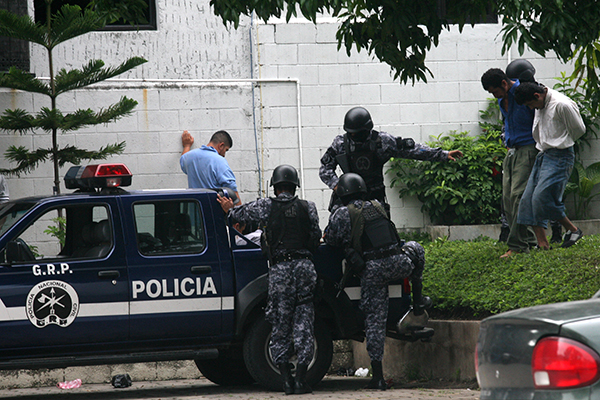 Police escort detainees to a court hearing in 2009 over the killing of freelancer Christian Poveda in El Salvador. Safety training is essential for journalists covering dangerous beats in Central America. (AP/Edgar Romero)