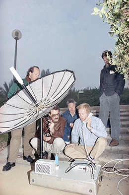 Broadcast journalists use a satellite phone to report from Baghdad during the 1991 Gulf War. Journalists say cumbersome equipment forced them to spend less time in dangerous areas in the past. (AP/Dominique Mollard)