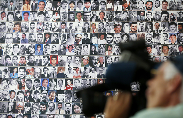 Photographs of journalists killed in action feature on a memorial wall at Washington DC’s Newseum. Freelancers and news outlets are rethinking safety in response to increased risk. (AP/Charles Dharapak)