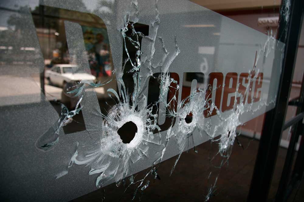 The entrance to Noroeste is covered with bullet holes after gunmen opened fire on the newspaper's regional office in the Pacific resort city of Mazatlán, Mexico, on September 1, 2010. (AP/Christiann Davis)
