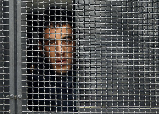 A police officer looks out of a bus during a patrol of Ismaili, Azerbaijan, January 25, 2013. (Reuters/David Mdzinarishvili)