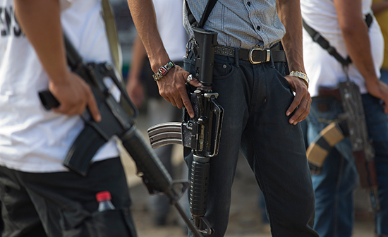 Members of a citizen's "self-defense" group patrol La Mira, Mexico, May 9, 2014. The Tierra Caliente region has been the site of fighting between organized crime and vigilante groups for years. (AP/Eduardo Verdugo)