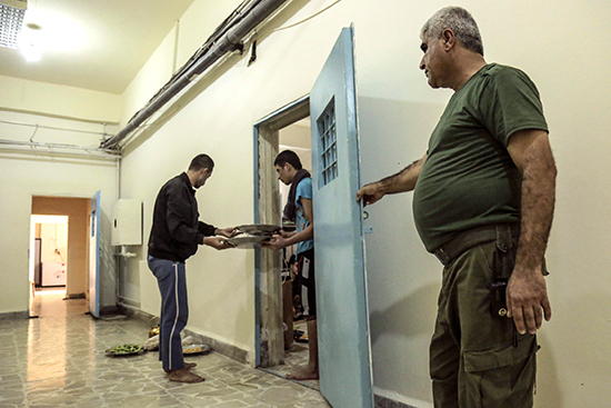 Kurdish security forces, or Asayish, feed prisoners in Derick Central Prison in Qamishli, northern Syria, November 16, 2016. (Reuters/Rodi Said)