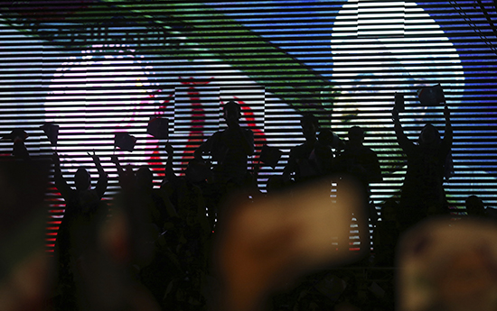 Supporters of Iran's President Hassan Rouhani wave flags during a campaign rally in Tehran on May 9. Iranian authorities have targeted messaging app Telegram ahead of the May 19 elections. (AP/Vahid Salemi)