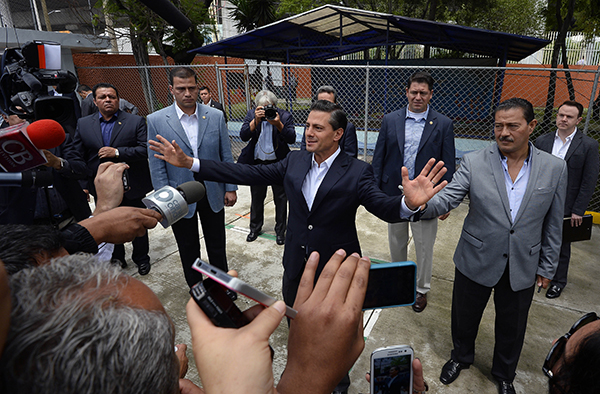 President Enrique Peña Nieto speaks with the press in Mexico City, in June 2015. Peña Nieto has publicly condemned attacks on journalists but more needs to be done to end the violence. (AFP/Alfredo Estrella)