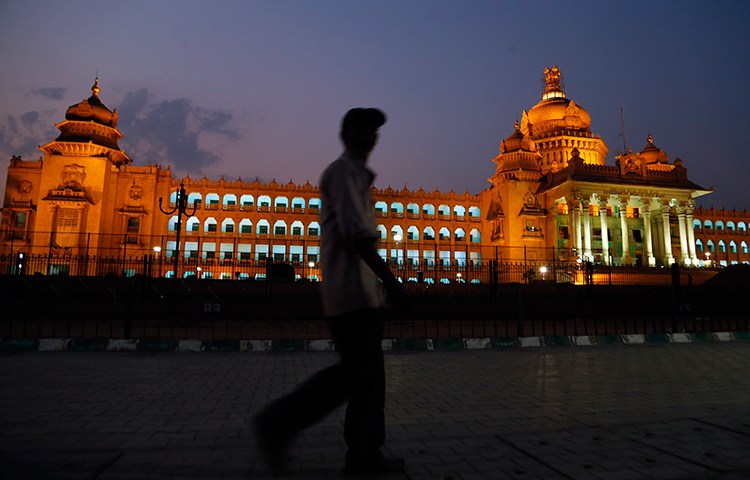 A man walks in front of the seat of the Karnataka state legislature in Bangalore, India, April 2, 2017. (AP/Aijaz Rahi)