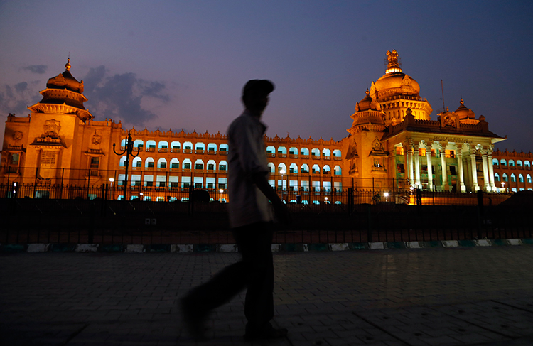 A man walks in front of the seat of the Karnataka state legislature in Bangalore, India, April 2, 2017. (AP/Aijaz Rahi)