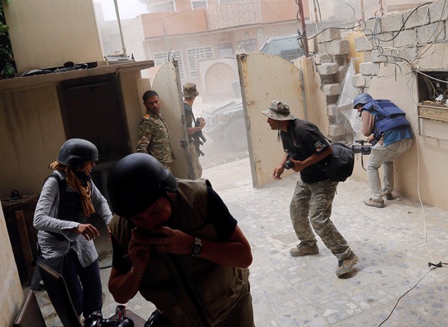 Journalists take cover as a car bomb explodes in Mosul, May 16, 2017. (Reuters/Danish Siddiqui)