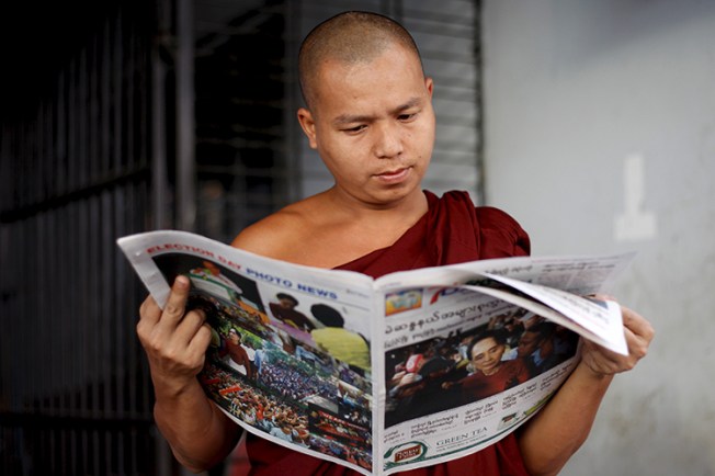 A monk reads the newspaper in Yangon, Myanmar, in this November 9, 2015 file photo. (Reuters/Soe Zeya Tun)