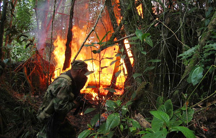 A soldier destroys chemicals used in the production of cocaine in Ragondalia, in the remote Colombian state of Norte de Santander, November 22, 2006. Dutch journalists Derk Johannes Bolt and Eugenio Ernest Marie Follender were abducted in the state, police said yesterday.