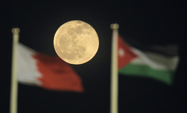 Qatar and Jordan's flags, pictured at a soccer match in Doha in 2011. Jordan has revoked the licence for Al-Jazeera amid tensions in the Gulf. (AFP/Karim Jaafar)