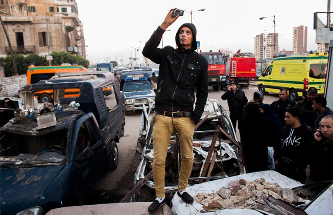 An Egyptian uses his phone to record the aftermath of a deadly explosion outside a police headquarters in December 2013. Journalists who use smartphones and messaging apps in their reporting say they are wary of surveillance and trolling under Egypt's press crackdown continues. (AP/Ahmed Ashraf)