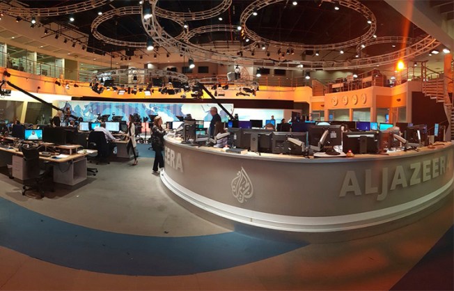 Al-Jazeera staff at the broadcaster's Doha headquarters in June 2017. Qatar's neighbors have demanded the country close the station as part of negotiations in the current political crisis. (AP/Malak Harb)