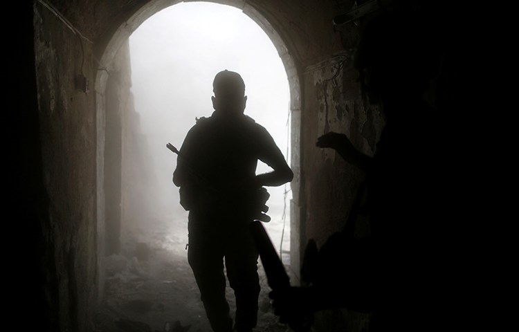 An Iraqi soldier looks for cover after a grenade explosion in the old city of Mosul, July 4, 2017. (Reuters/Ahmed Jadallah)