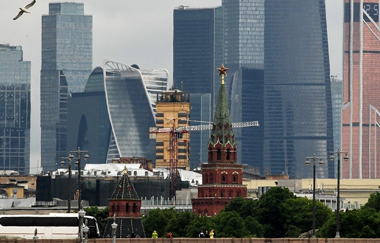 Tourists take photos of the Moscow skyline. A journalist based in the city says he has received anonymous threatening text messages over his reporting. (AFP/Kirill Kudryavtsev)