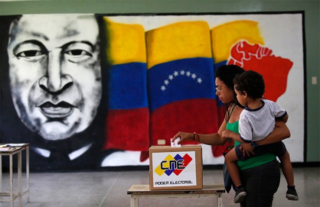 A woman casts her vote at a polling station during the Constituent Assembly election in Caracas on July 30. Journalists covering the vote and unrest in Venezuela have been arbitrarily detained, attacked, and threatened. (Reuters/Carlos Garcia Rawlins)