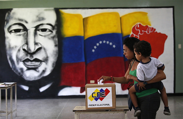 A woman casts her vote at a polling station during the Constituent Assembly election in Caracas on July 30. Journalists covering the vote and unrest in Venezuela have been arbitrarily detained, attacked, and threatened. (Reuters/Carlos Garcia Rawlins)