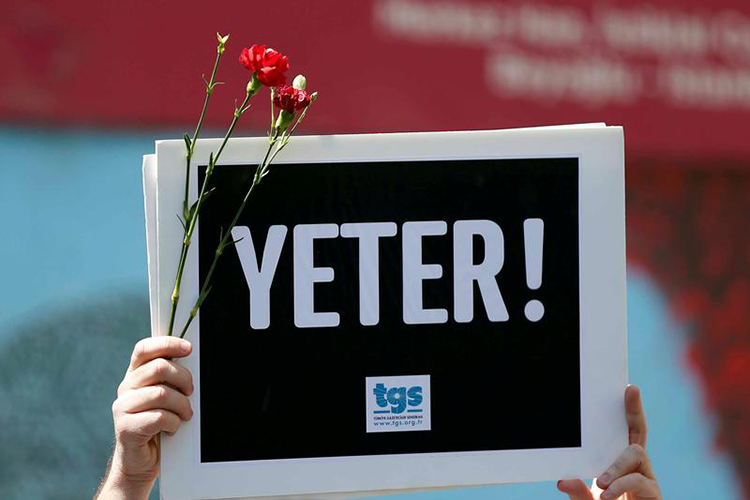 A member of the Journalists Union of Turkey TGS holds a sign reading "Enough" in a protest in Istanbul to mark World Press Freedom Day, May 3, 2017. (Reuters/Murad Sezer)