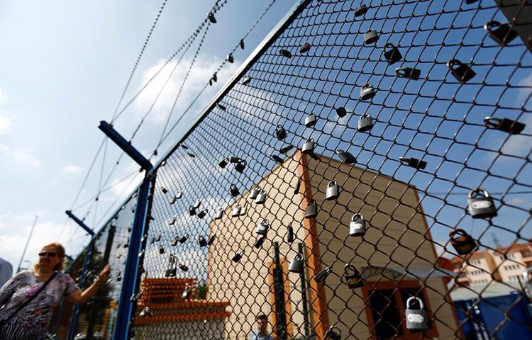 A demonstrator stands next to padlocks left by prisoners in Istanbul's Metris Prison during a protest against the arrest of journalists and press freedom advocates, June 24, 2016. (Reuters/Murad Sezer)