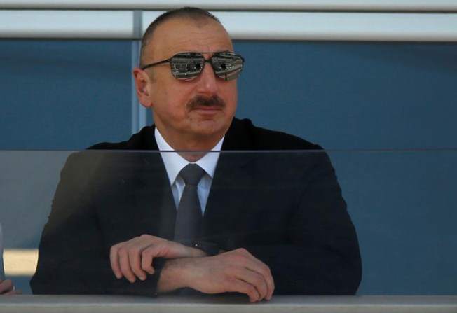 Azerbaijani President Ilham Aliyev, shown here watching a parade before a Formula 1 race in Baku, June 25, 2017, has maintained strict control over the media over the course of his 14-year rule. (Reuters/David Mdzinarishvili)