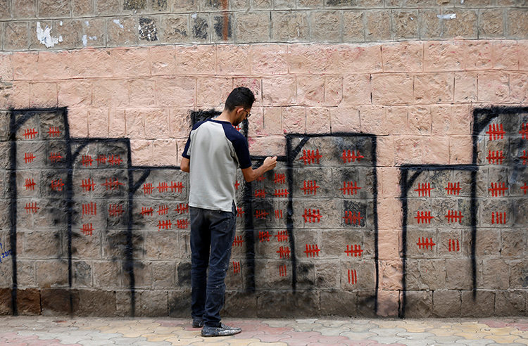 Artist and activist Thiyazen al-Alawi paints a mural on a wall of a hospital in Sanaa as part of a cholera-awareness campaign. In one of the biggest outbreaks of the disease in modern history, more than 425,000 people in Yemen have contracted cholera, nearly 2,000 of whom have died, since the Saudi-led coalition began bombing the country in 2015. (REUTERS/Khaled Abdullah)