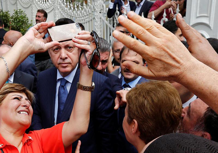 A woman takes a selfie with Turkish President Recep Tayyip Erdoğan in Istanbul, August 4, 2017. (Reuters/Murad Sezer)