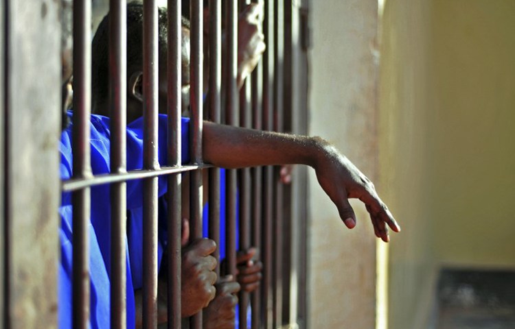 Prisoners stand behind bars in Garowe, Puntland, December 14, 2016. (AFP/Mohamed Abdiwahab)