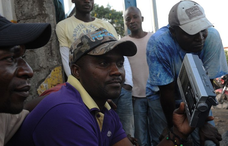 Congolese men listen to the radio in Goma, Democratic Republic of the Congo, December 11, 2011. (AFP/Simon Maina)