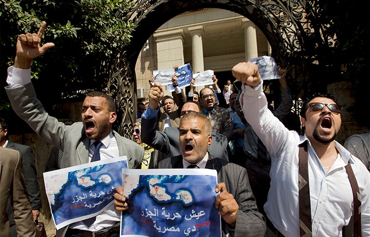 Dozens of Egyptians shout slogans during a protest in Cairo against an accord to hand over control of two Red Sea islands to Saudi Arabia. Journalist Hany Salah el-Deen is arrested on accusations of 'inciting protests.' (AP/Amr Nabil)