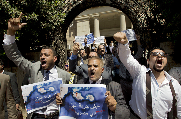 Dozens of Egyptians shout slogans during a protest in Cairo against an accord to hand over control of two Red Sea islands to Saudi Arabia. Journalist Hany Salah el-Deen is arrested on accusations of 'inciting protests.' (AP/Amr Nabil)