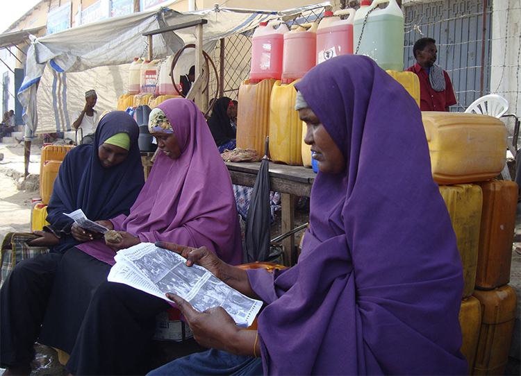 Women read newspapers in a Mogadishu market in 2010. Somali authorities are proposing changes to the country's media law, that include new restrictions for the press. (Reuters/Feisal Omar)