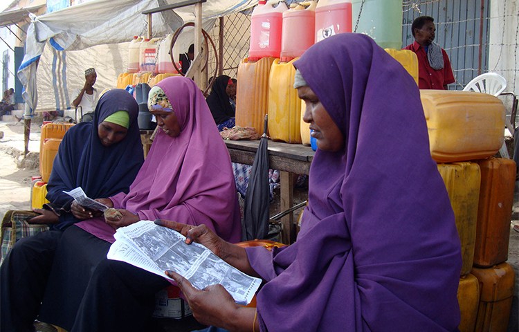 Women read newspapers in a Mogadishu market in 2010. Somali authorities are proposing changes to the country's media law, that include new restrictions for the press. (Reuters/Feisal Omar)