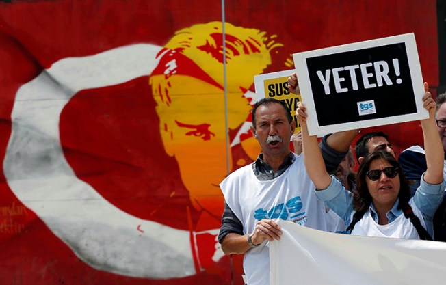 Members of the Journalists Union of Turkey shout slogans during a demonstration to mark World Press Freedom Day in Istanbul, Turkey on May 3. The placard reads: "Enough!" (Reuters/Murad Sezer)