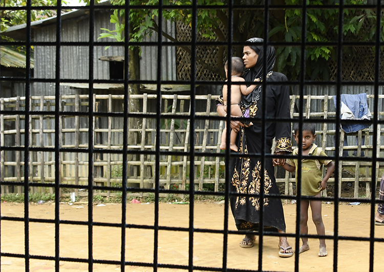 Rohingya Muslim refugees stand on a street in the Bangladeshi town of Ukhia on September 15, 2017. Bangladesh has detained two Myanmar journalists who are reporting on the crisis. (AFP/Dominique Faget)