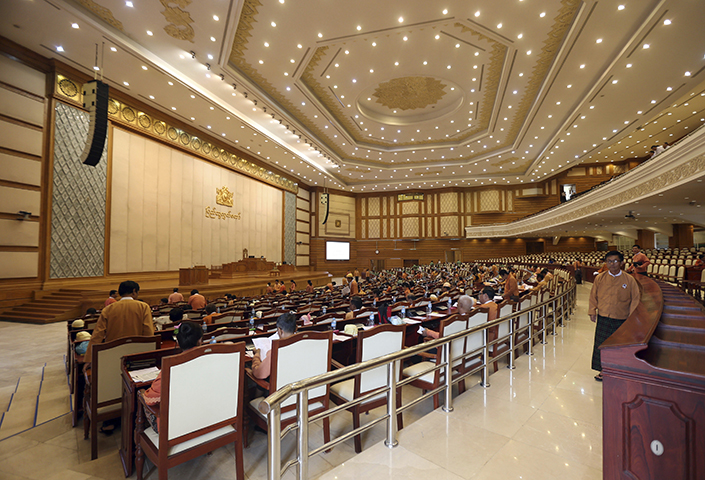 Lawmakers attend a regular session of the lower house of parliament in Naypyitaw, Myanmar on Monday, June 19, 2017. Myanmar authorities on October 27 detained two foreign reporters, along with their interpreter and driver, after the journalists flew a drone near the country's parliament building. (AP/Aung Shine Oo)