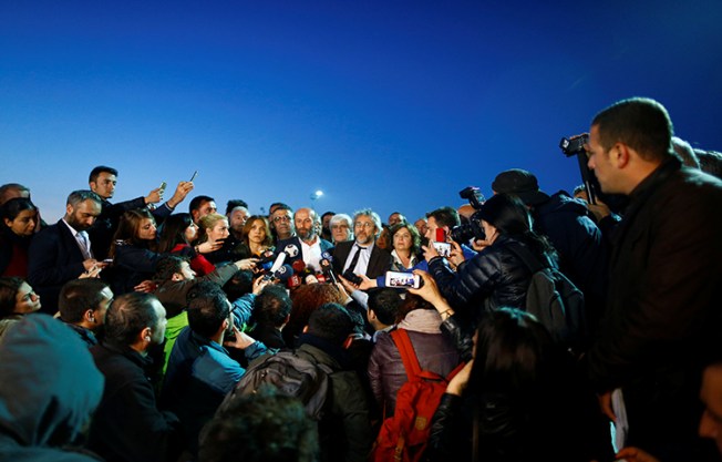 Can Dundar, editor-in-chief of the Cumhuriyet, accompanied by his Ankara bureau chief Erdem Gul, talks to media as they leave the Justice Palace in Istanbul, Turkey May 6, 2016. Dundar is now in exile in Germany. (Reuters/Osman Orsal)