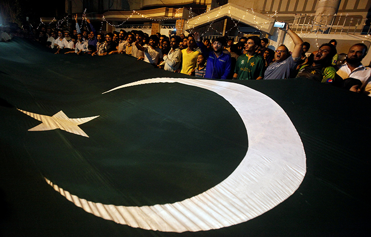 Pakistan's cricket fans wave a national flag in Karachi, Pakistan on June 20, 2017. Pakistan's interior ministry ordered he Interior Ministry on January 19, 2018 ordered the Pashto-language service of U.S. Congress-funded Radio Free Europe/Radio Liberty, Radio Mashaal, to close immediately. (Reuters/Akhtar Soomro)