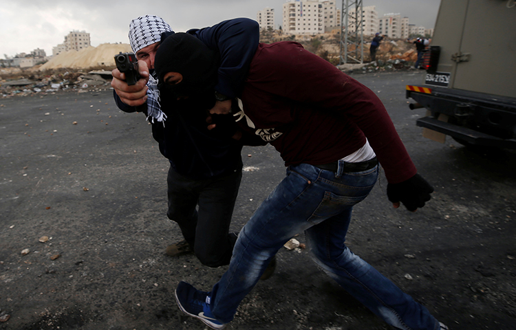 Undercover Israeli security personnel detain a Palestinian demonstrator during clashes at a protest against U.S. President Donald Trump's decision to recognize Jerusalem as the capital of Israel, near the Jewish settlement of Beit El, near the West Bank city of Ramallah December 13, 2017. (Reuters/Mohamad Torokman)