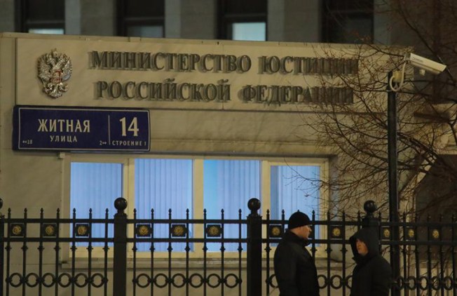 People stand outside Russia's Justice Ministry on December 4, 2017. Moscow has designated nine U.S. government-funded outlets to register as foreign agents. (Reuters/Maxim Shemetov)